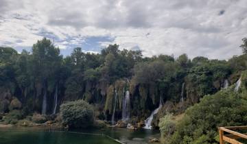 Waterfalls surrounded by lush greenery.