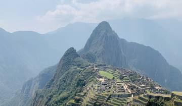 Iconic ruins on a mountain with misty hills.
