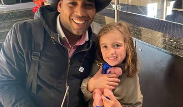 Man and child smiling, sitting together.