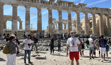 Tourists visiting the ancient ruins of the Acropolis.