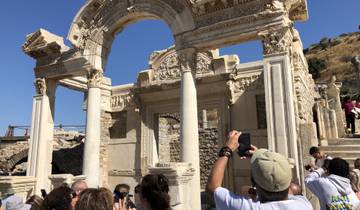 Tourists taking photos of historical ruins.