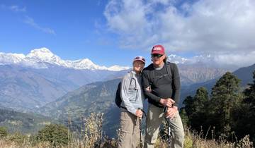 Couple standing with trekking poles in the Himalayas.