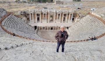 Person standing in an ancient amphitheater.