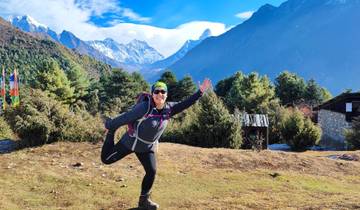 Person posing with scenic mountain view.