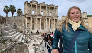 Tourists at an ancient ruin site with large columns.