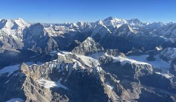 Stunning panoramic view of snowy mountain peaks with clear sky.