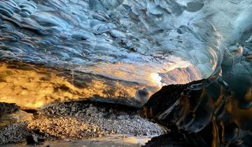 Vibrant ice cave interior with warm and cool tones.