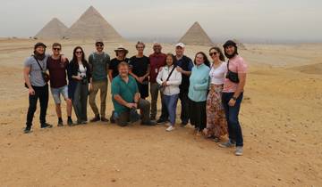 Group of people with pyramids in the background.