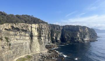 Cliffs overlooking the ocean with clear skies in Tasmania.