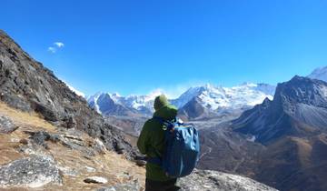Backpacker enjoying the view of snowy mountains