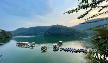 Serene lakeside view with colorful boats.