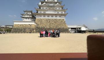 Group in front of a historical castle with clear sky.