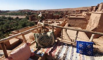 Scenic view from a terrace with traditional decor over a valley.