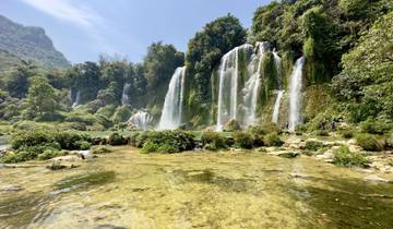 Waterfalls surrounded by lush vegetation.