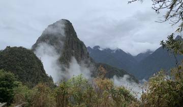 Cloud-covered mountains with lush greenery.
