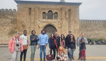 Group of tourists in front of a historical building.
