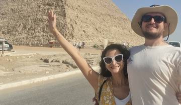 People posing in front of a historical structure.