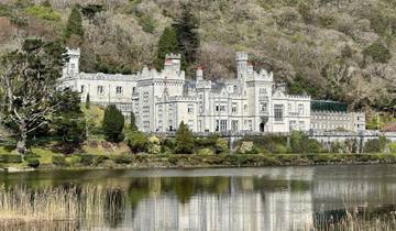 Stunning view of an architecturally impressive castle by a lake.