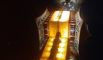 Illuminated traditional Korean bridge at night.