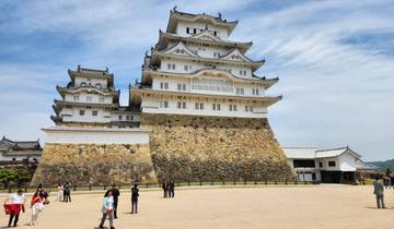 Himeji Castle with people on the grounds, sharply captured.