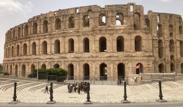 Ancient Roman amphitheater with people in the foreground.