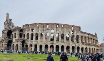 Colosseum in Rome with tourists in the foreground.