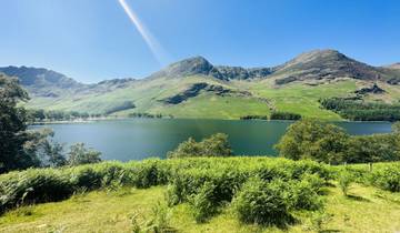 Stunning view of a mountain lake surrounded by lush greenery.