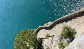 A scenic coastal pathway with blue water.