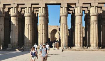 Historic columns with people exploring the site.