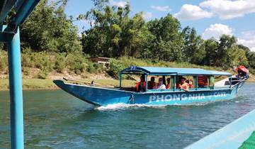 A boat labeled 'Phong Nha Cave' with passengers.