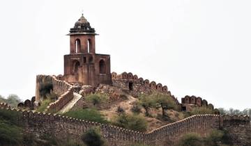 Ancient fortress with a tower surrounded by walls.