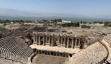 Ancient theatre in Pamukkale with surrounding ruins.