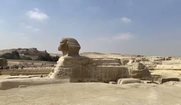 The Sphinx statue with arid landscape in the background.