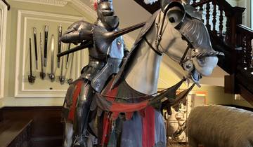 Medieval knight armor on a horse display indoors.