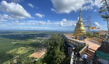 Temple perched on a hill with vast landscape view.