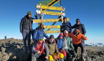 Group of people at Uhuru Peak on Mount Kilimanjaro, Tanzania.