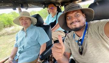 Group inside a safari jeep with thumbs up.