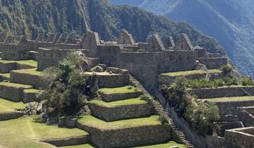 Ancient stone ruins on a mountain with clear skies.