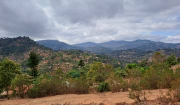 Hilly landscape with villages and dense vegetation.