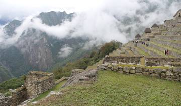Terraced ancient structures with misty mountain backdrop.