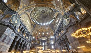 Interior of a domed structure with calligraphy and stained glass.