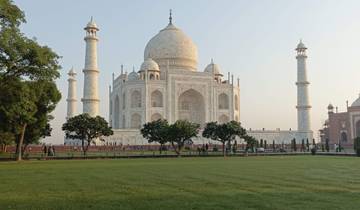 The Taj Mahal in Agra with green lawns in the foreground.