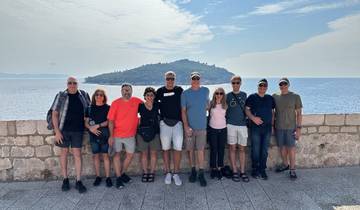 Group of people posing on a terrace with sea view.