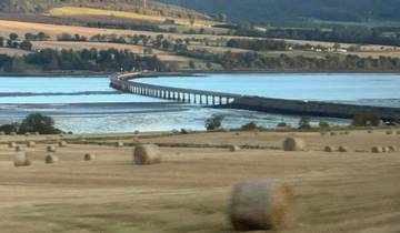 Scenic view of a railway bridge crossing through fields.