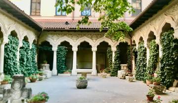 Ornate courtyard with arches and greenery.