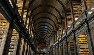 Long Room of a historic library with arched wooden ceilings and shelves.