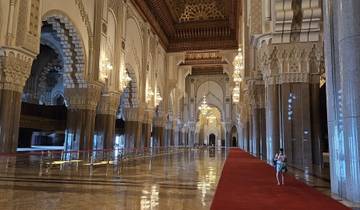 Elaborate interior of a grand mosque with chandeliers.