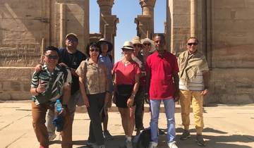Group of tourists posing at an archaeological site.
