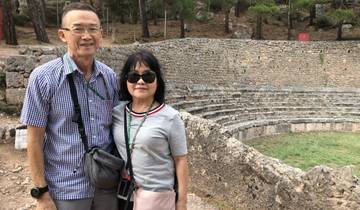Couple posing in front of ancient ruins.