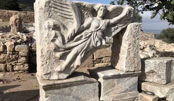 Carved stone relief depicting a winged figure.